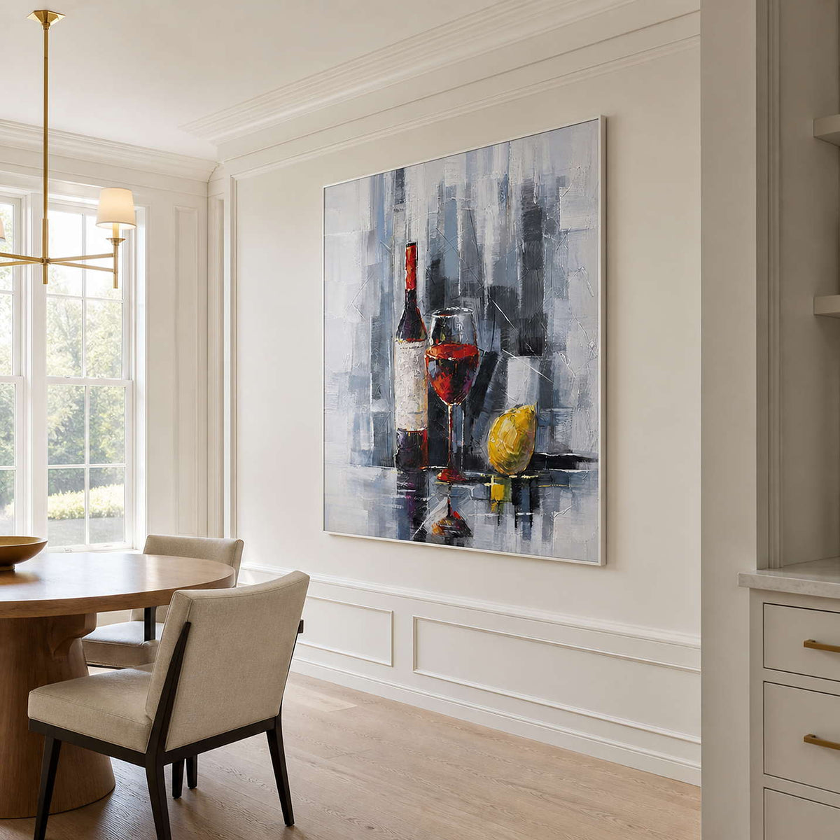 White framed wine and lemon painting beside a round breakfast table.