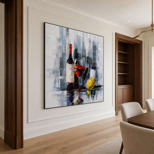 Black framed wine and lemon artwork beside dining chairs and wooden shelving.