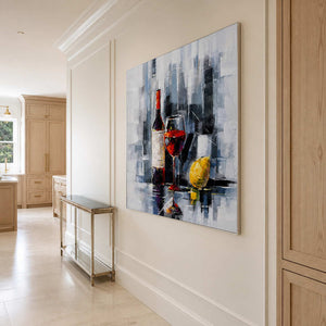 Silver framed wine still life along a pale hallway leading toward the kitchen.