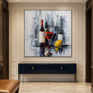 Black framed wine still life above a navy console in a paneled hallway.