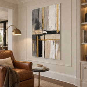 Gold-lined abstract artwork beside a brown reading chair, curved lamp, and built-in bookshelves.