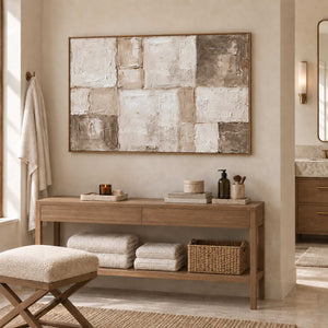 Time in Soft Focus in a wood frame above a console holding towels and woven storage in a bathroom dry area.