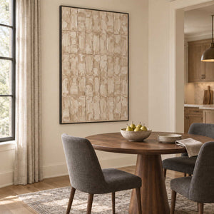 Time in Verse in a black frame beside a round wood dining table with charcoal upholstered chairs.