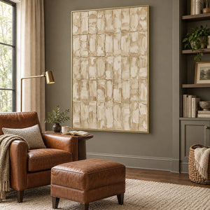 Time in Verse in a gold frame beside a brown leather armchair and matching footstool in a quiet reading nook.