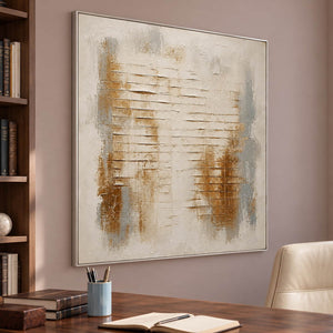 Ivory abstract painting with warm gold patches and horizontal raised lines in a silver frame in a home office.