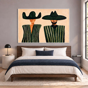 Paired portrait above a bed with white bedding and a navy throw.
