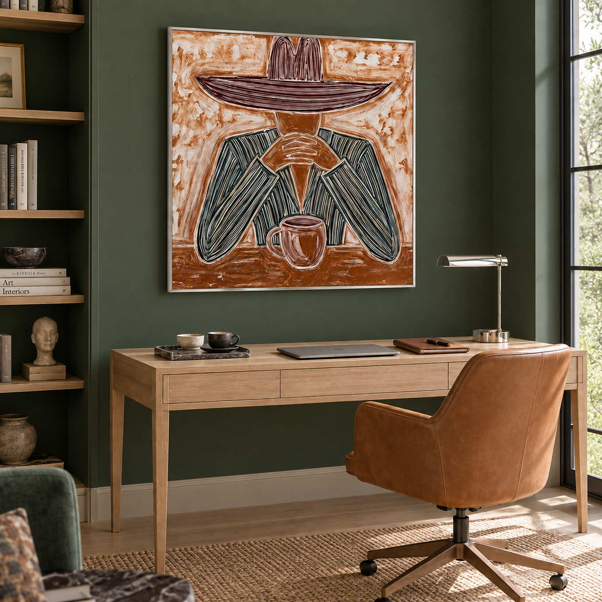 Time to Linger in a silver frame above a light wood desk and tan leather chair against a deep green wall.
