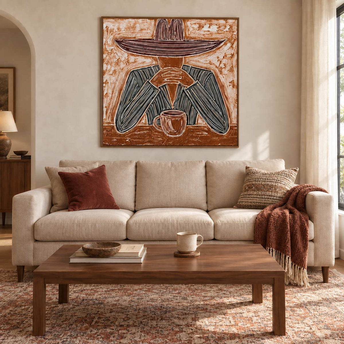 Time to Linger in a wood frame above a cream sofa with rust cushions and a rectangular wood coffee table.