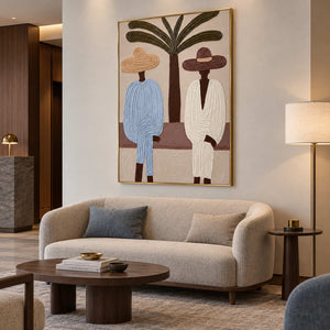 Tall palm and figures painting above a rounded cream sofa in a softly lit lounge.