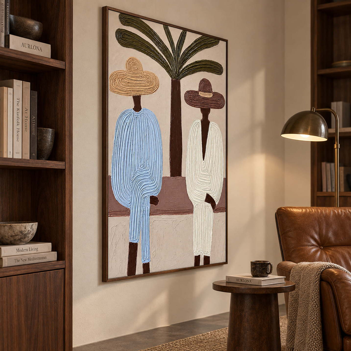 Blue and cream figurative artwork beside a leather reading chair and dark wood bookshelves.