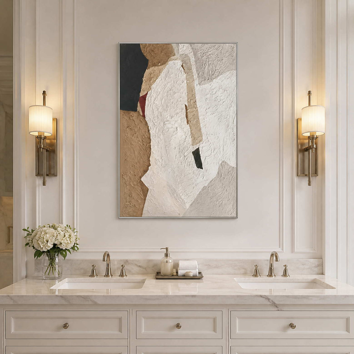 Silver framed white and sand abstract artwork above a double vanity between softly glowing sconces.