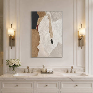 Silver framed white and sand abstract artwork above a double vanity between softly glowing sconces.