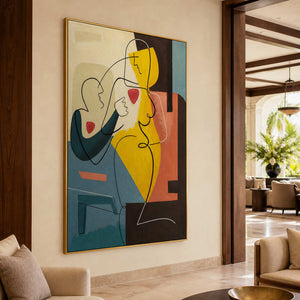 Gold-framed yellow and teal figurative painting beside a wood-paneled opening in a softly furnished hotel lounge.