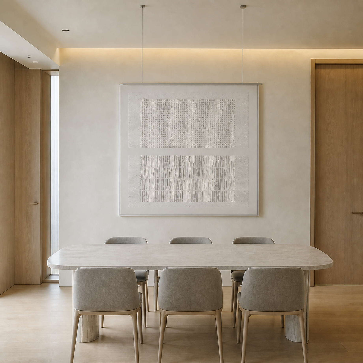 Monochrome relief canvas displayed above an elegant dining table.