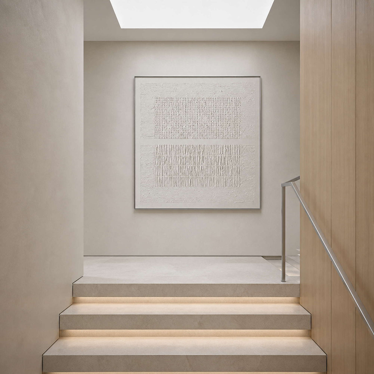 Minimalist white canvas displayed at a light-filled stair landing.
