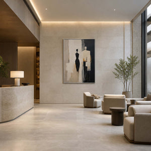Textured figurative wall art displayed in a beige-gray boutique hotel lobby.