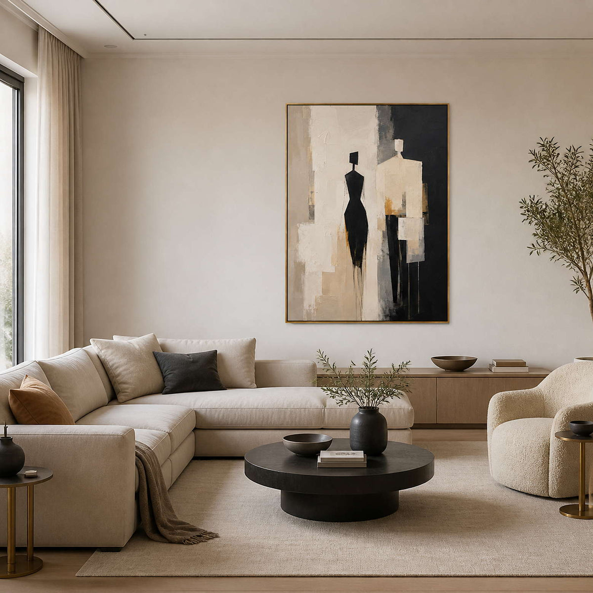 Textured figurative wall art displayed in a cream-and-black modern living room.