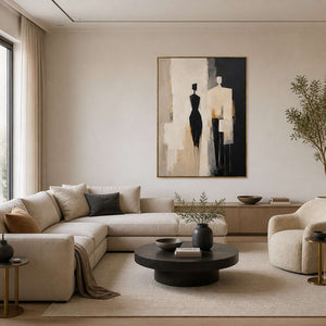 Textured figurative wall art displayed in a cream-and-black modern living room.