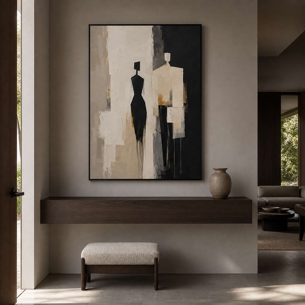 Textured figurative wall art displayed in a warm gray entryway.