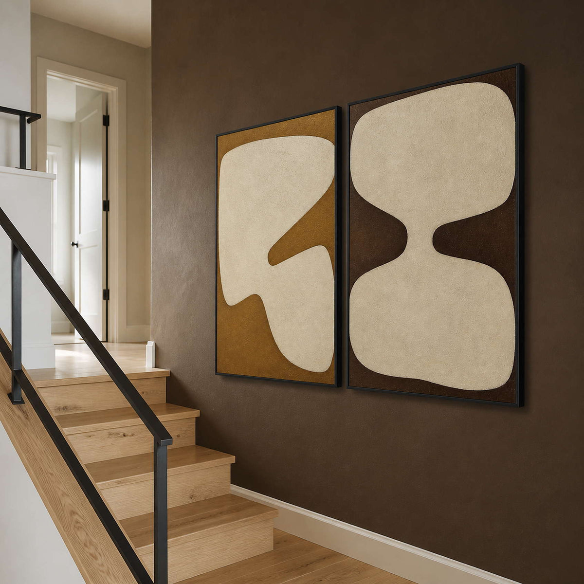 Earth-tone abstract panels viewed beside a deep brown residential staircase.