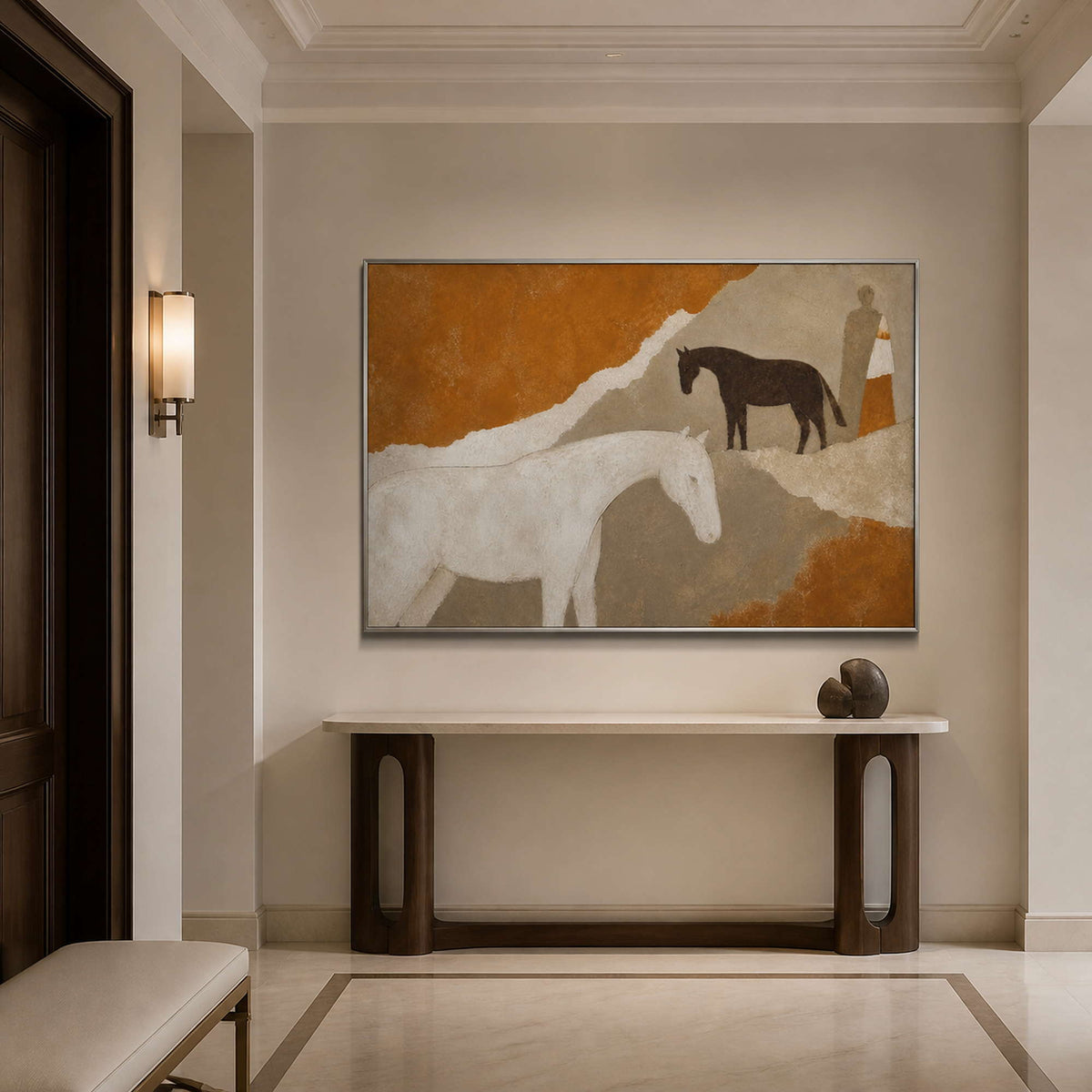 Neutral horse artwork in a silver frame styled in an elegant entryway.