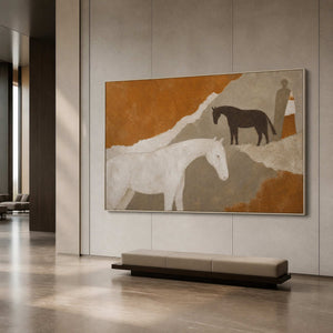 Modern neutral horse artwork in a silver frame inside a spacious lobby.
