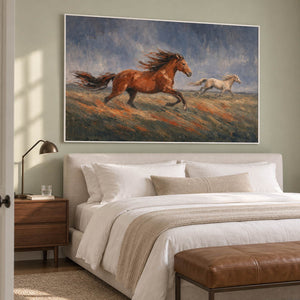 Hand-painted scene of chestnut and pale horses running across open ground, displayed in a bedroom in a white frame.
