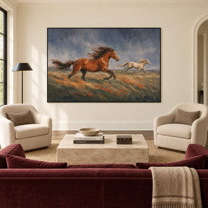 Hand-painted scene of chestnut and pale horses running across open ground, displayed in a living room in a black frame.