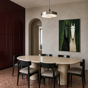 Two-horse wall art displayed above a sculptural modern dining table.