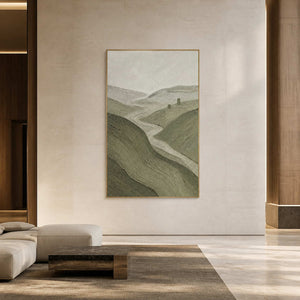 Large vertical landscape wall art in a modern hotel lobby with a gold frame.