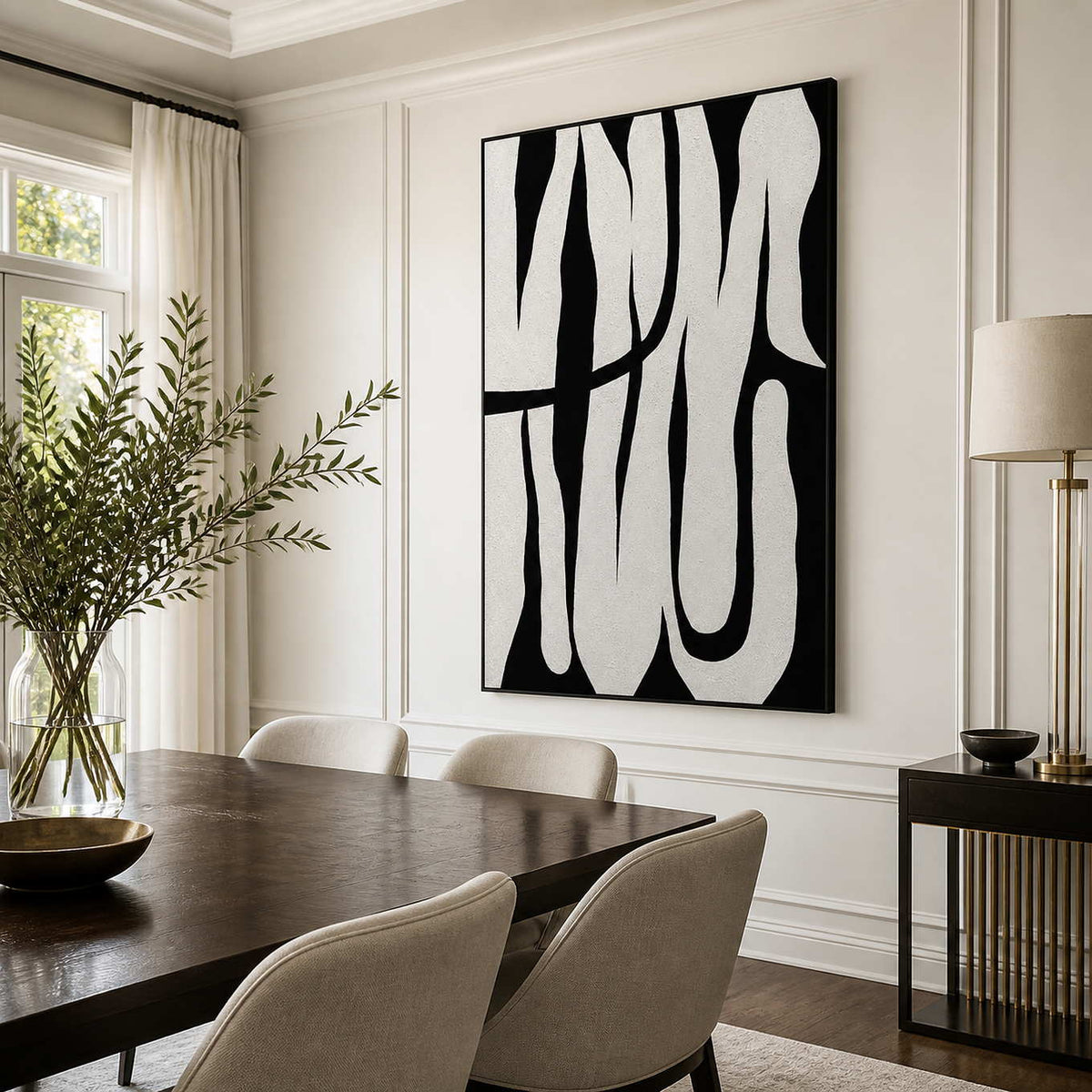 Black framed monochrome curved artwork above a dark dining table with pale upholstered chairs.