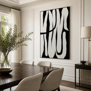 Black framed monochrome curved artwork above a dark dining table with pale upholstered chairs.