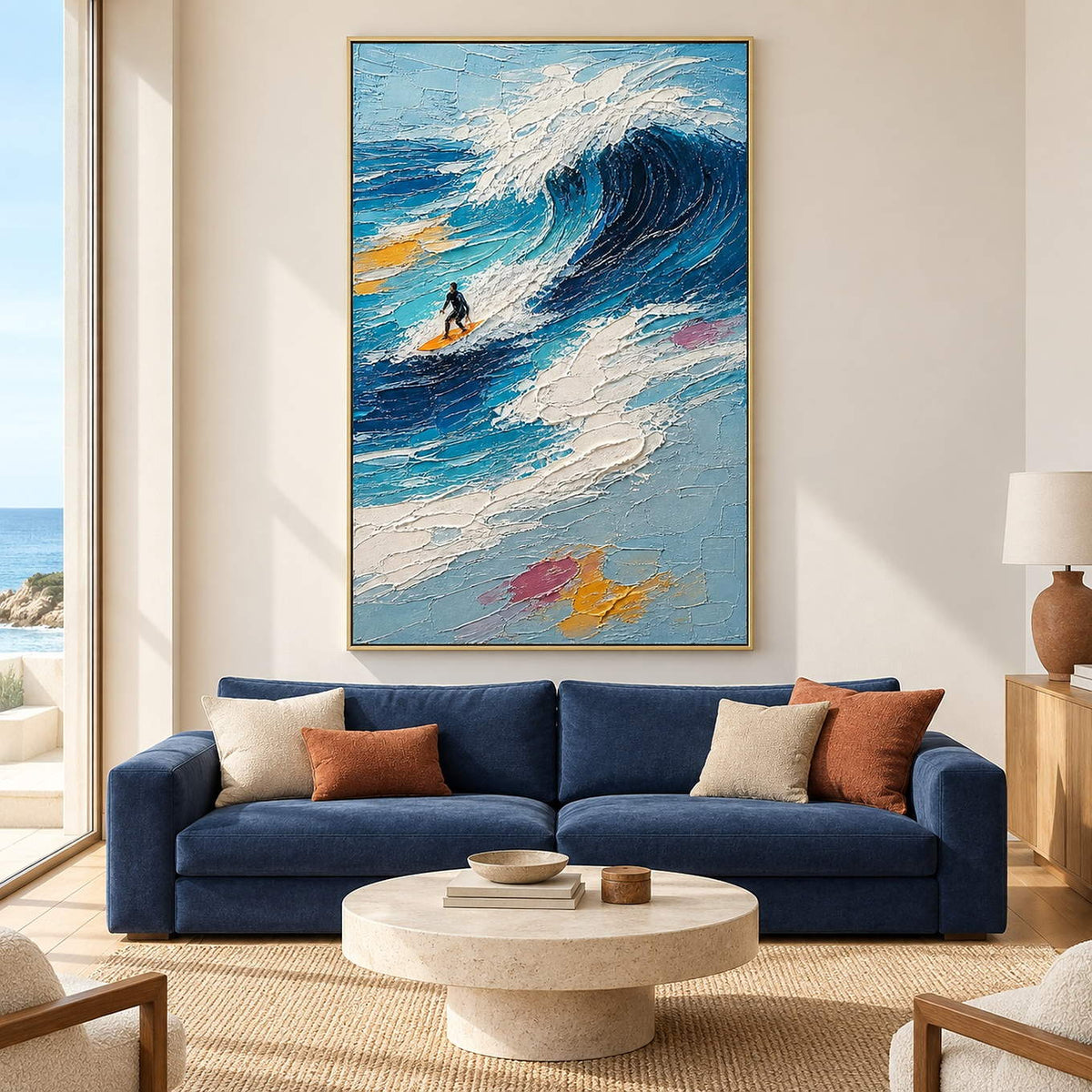 Textured surfing painting with a lone surfer beneath a dark blue breaking wave in a gold frame in a living room.
