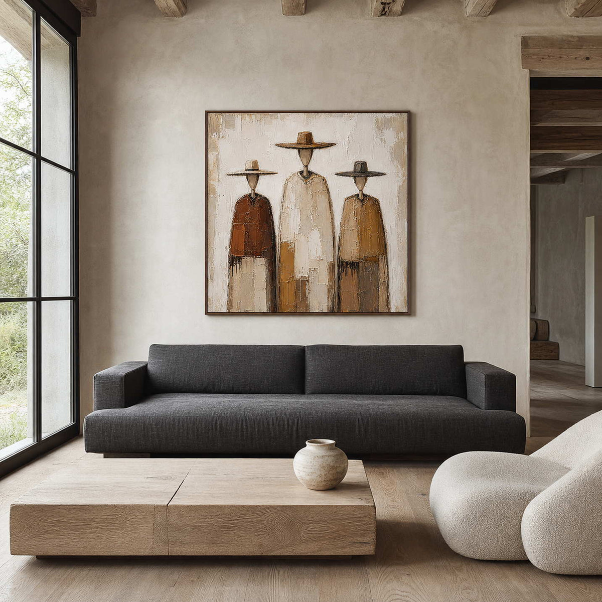 Textured western wall art displayed above a modern neutral living room sofa.