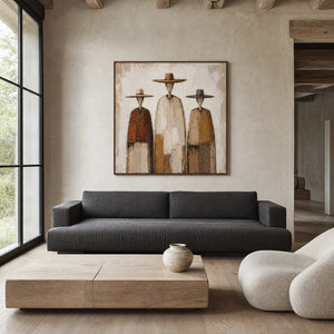 Textured western wall art displayed above a modern neutral living room sofa.