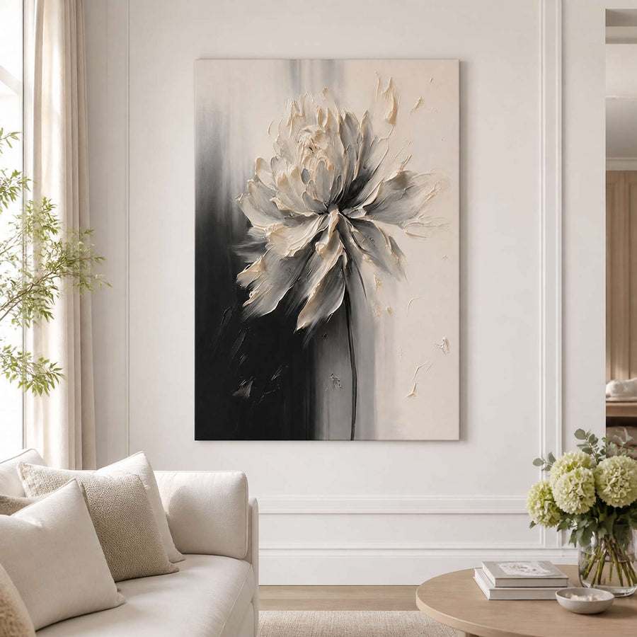 Frameless ivory floral artwork beside a cream sofa in a bright living room.