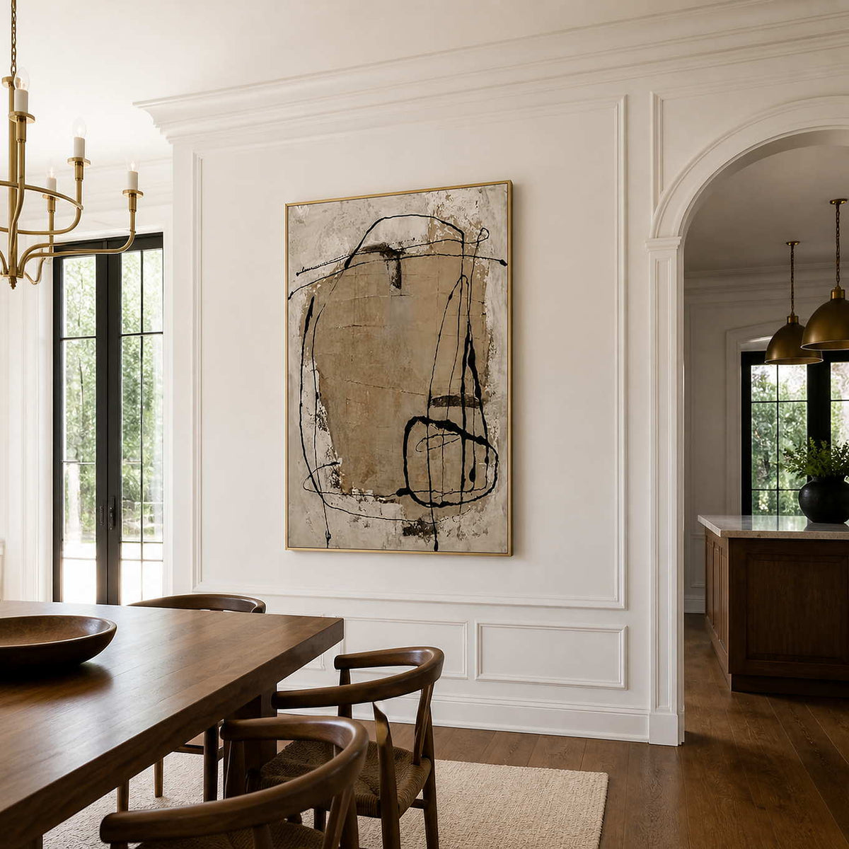 Gold-framed abstract wall art brings cream and sand tones to a dining room.