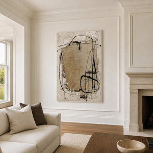 White-framed abstract wall art beside a fireplace in an elegant living room.