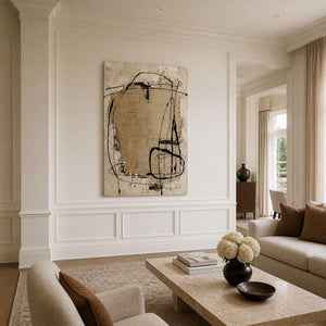 Abstract wall art with wandering black lines in a neutral living room.