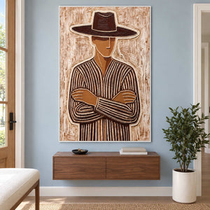 Striped figure painting above a floating wooden cabinet beside a tall potted plant.