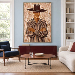 Folded-arm portrait above a burgundy cabinet between a navy chair and cream sofa.