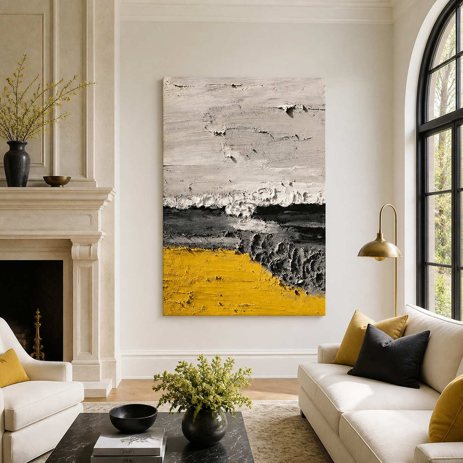 Frameless yellow and charcoal abstract artwork beside a fireplace in a bright living room.