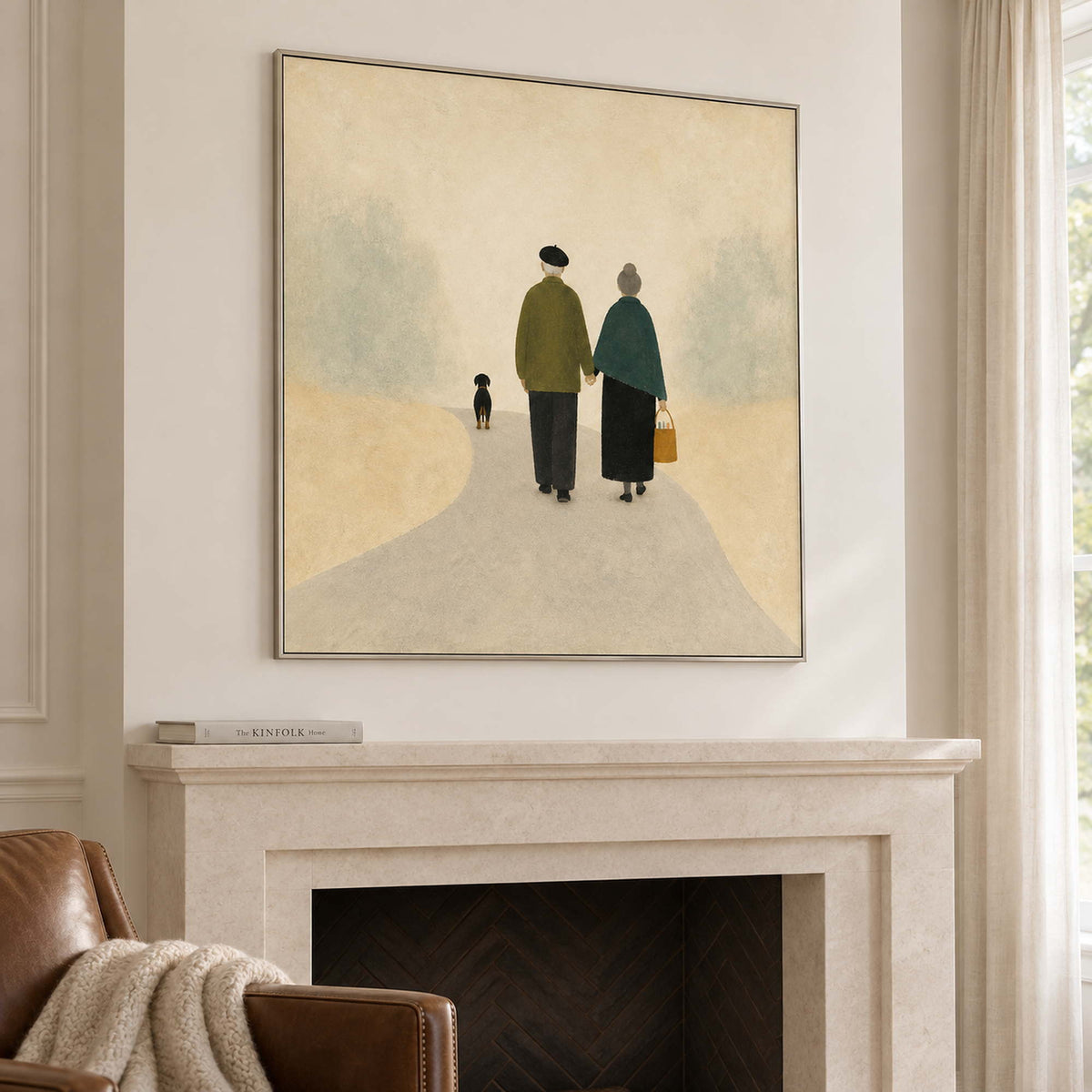A couple walking away with a small dog on a pale path in a silver frame, displayed above a fireplace.