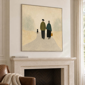 A couple walking away with a small dog on a pale path in a silver frame, displayed above a fireplace.