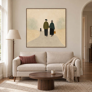 A couple walking away with a small dog on a pale path in a brown wood frame, displayed above a sofa in a living room.