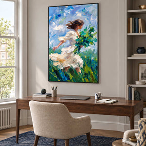 Walking into the Breeze in a black frame above a wood desk and cream chair beside shelves and a bright window.