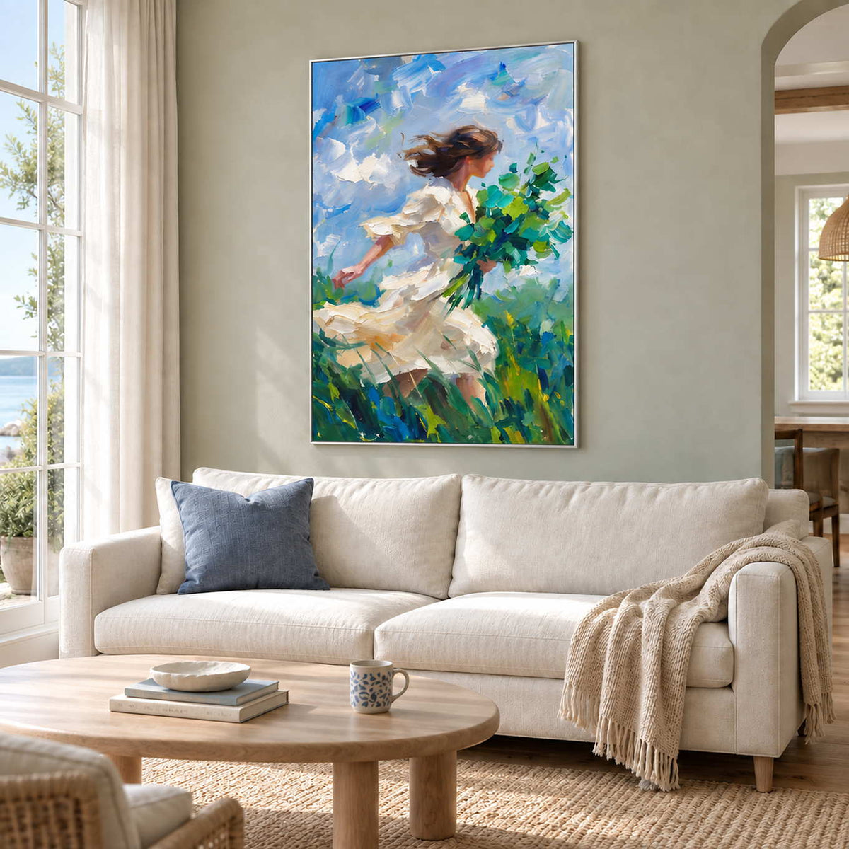 Walking into the Breeze in a silver frame above a cream sofa with a blue cushion and a light wood table.
