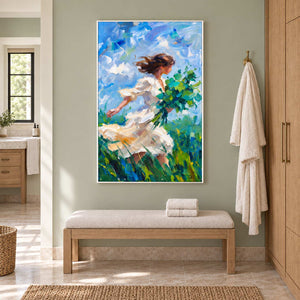 Walking into the Breeze in a white frame above a cream bench with folded towels against a sage bathroom wall.