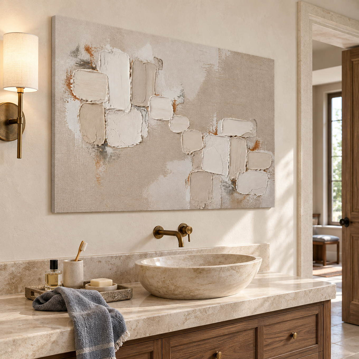 Textured abstract painting with raised ivory and taupe blocks without an outer frame beside a bathroom vanity.