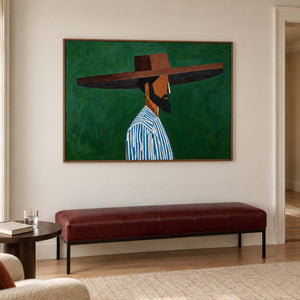 Horizontal figure painting over a burgundy bench beside a small round side table.